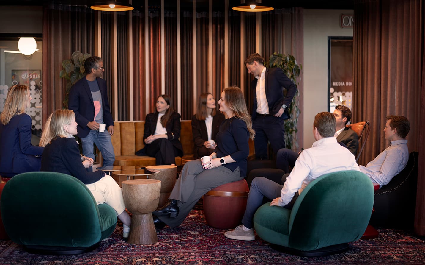 Wider team gathering in the office lounge.